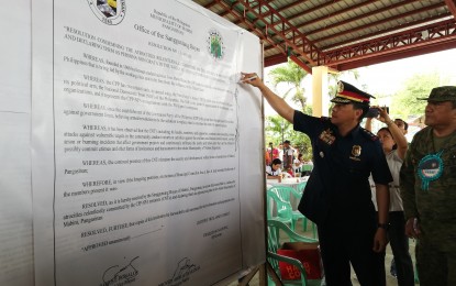<p><strong>CPP-NPA DECLARED PERSONA NON GRATA.</strong> Pangasinan Police Provincial director, Col. Redrico Maranan (2nd from right) and 702nd Brigade deputy commander, Col. Angel Madarang sign the resolution declaring CPP-NPA as persona non grata during the ceremonial signing in Mabini, Pangasinan on Wednesday (Nov. 20, 2019). The resolution also condemned the atrocities of the terrorist group. <em>(Photo by Hilda Austria)</em></p>