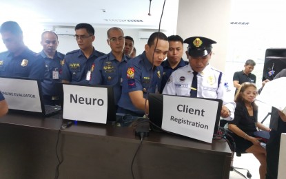 <p><strong>ONLINE APPLICATION.</strong> A security guard, along with ranking police officials, try the online application for security personnel's license launched in Camp Crame on Wednesday (Nov. 20, 2019). CSG director, Maj. Gen. Roberto Fajardo said the launching of an online License to Exercise Security Profession (LESP) is aimed at curbing long lines of processing of LESP for those in the security profession and lessening corruption. <em>(PNA photo by Lloyd Caliwan)</em></p>