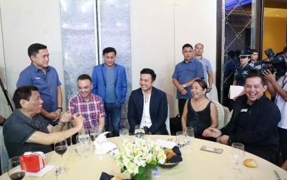 <p><strong>TERM-SHARING</strong>. President Rodrigo Roa Duterte shares a light moment with some of the distinguished guests during the Hugpong ng Pagbabago (HNP) Thanksgiving Night at the Peninsula Manila in Makati City on June 24, 2019. With the President are (from left) Senator Bong Go, House Speaker Alan Peter Cayetano, Senator Francis Tolentino, Marinduque Rep. Lord Allan Velasco, House Speaker Gloria Macapagal-Arroyo, and Leyte First District Rep. Martin Romualdez. Duterte on Sunday (Nov. 24, 2019) says Cayetano and Velasco should honor term-sharing for House speakership. <em>(Presidential photo of Karl Norman)</em></p>
