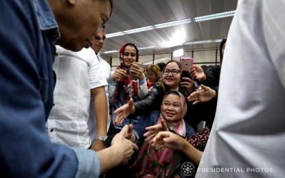 <p><strong>PRO-WOMEN POLICIES</strong>. President Rodrigo Roa Duterte interacts with Overseas Filipino Worker (OFW) amnesty availees from Kuwait whom he welcomed at the Ninoy Aquino International Airport in Pasay City on February 12, 2018. Duterte vowed to pursue policies that will protect women and children from harassment as he joined the nation in the observance of the National Consciousness Day for the Elimination of Violence Against Women on Monday (Nov. 25, 2019). <em>(Presidential photo of Simeon Celi Jr.)</em></p>