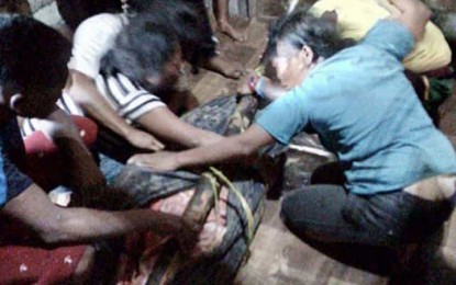 <p><strong>SLAIN TRIBAL FARMER.</strong> Authorities recover the body of Roy Olmo Biyog, 23, a farmer and a member of the Mamanwa tribe. Authorities say Biyog was killed on November 18, 2019 by communist rebels who accused him of being a military asset. <em>(Photo courtesy of the Army's 402nd Infantry Brigade)</em></p>