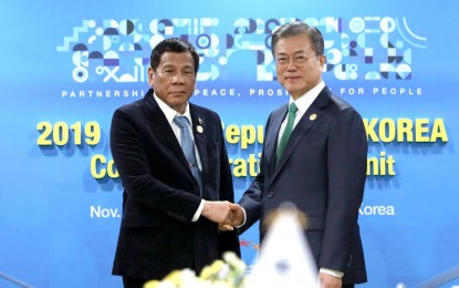 <p><strong>BILATERAL MEET</strong>. President Rodrigo Duterte and Republic of Korea President Moon Jae-in pose for posterity before the start of their bilateral meeting at The Westin Chosun Busan Hotel on Monday (Nov. 25, 2019). The meeting was held on the sidelines of the Association of Southeast Asian Nations - Republic of Korea Commemorative Summit in Busan, South Korea. <em>(Presidential photo by Robinson Niñal)</em></p>