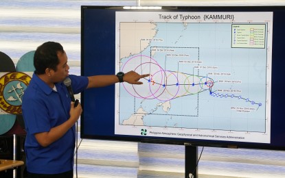 <p><strong>‘KAMMURI'.</strong> Philippine Atmospheric, Geophysical and Astronomical Services Administration (PAGASA) weather specialist Raymond Ordinario shows the direction of Typhoon Kammuri during a press conference held at PAGASA’s office in Diliman, Quezon City on Thursday (Nov. 28, 2019).  The weather bureau is closely monitoring “Kammuri’s” movement as it is set to enter the Philippine area of responsibility on Saturday morning. As of 10 a.m., "Kammuri" was located 1,430 km. east of the Visayas with maximum sustained winds of 120 kph and gustiness of up to 150 kph.<em> (PNA photo by Ben Briones)</em></p>