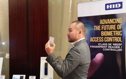 <p><strong>BIOMETRICS</strong>. Christian Marcos, HID Global's regional sales manager in the Philippines, says the firm's new fingerprint reader stores a person's fingerprint template in the card, which he or she will keep. The firm introduced its new fingerprint reader on Tuesday (Nov. 26, 2019) in Makati City. (<em>PNA photo by Cristina Arayata</em>) </p>