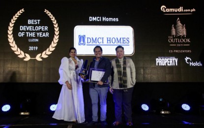 <p>Corporate Communications Manager Carlo Gahol (middle) receives the award on behalf of DMCI Homes <em>(DMCI Homes photo)</em></p>