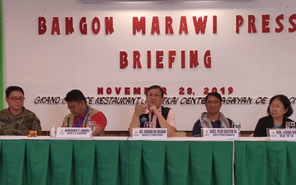 <p><strong>MARAWI REHAB UPDATE.</strong> Task Force Bangon Marawi chairperson Edgardo del Rosario (center) gives a briefer on the press in Cagayan de Oro City on Thursday (Nov. 28, 2019). The official says the construction of new public infrastructures in the most affected area (MAA) of Marawi City will start this December after retrieval and disposal of unexploded bombs is almost complete.<em> (PNA photo by Ercel Maandig)</em></p>