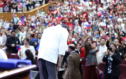 <p><strong>MOST POPULAR</strong>. President Rodrigo Roa Duterte shows a gesture of respect in front of overseas Filipino workers during his visit Jordan in September 2018. A 2022 Second Quarter survey conducted by PUBLiCUS described Duterte as “the most popular president of the post-Edsa 1 era.” <em>(Presidential photo)</em></p>