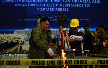 <p><strong>DECOMMISSIONED.</strong> Soldiers help government officials in the decommissioning of turned-in firearms during a ceremony held at the Phil. Army’s 4th Infantry Division in Barangay Patag, Cagayan de Oro, on Thursday afternoon.<em> (PNA photo by Jigger J. Jerusalem)</em></p>