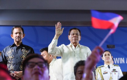 <p><strong>SEA GAMES HOSTING</strong>. President Rodrigo Duterte waves to acknowledge members of the Team Philippines during the traditional parade in the opening ceremonies of the 30th Southeast Asian Games at the Philippine Arena in Bocaue, Bulacan on November 30, 2019. Duterte was joined by the Sultan of Brunei, Haji Hassanal Bolkiah. <em>(File photo)</em></p>