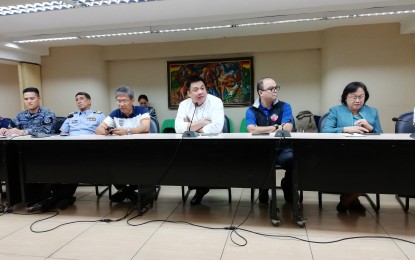<p><strong>READY FOR ‘TISOY’.</strong> Metropolitan Manila Development Authority (MMDA) General Manager Arturo "Jojo" Garcia (4th from left), Philippine Coast Guard spokesperson, Capt. Armando Balilo (2nd from left), and other officials discuss the preparations being readied in Metro Manila prior to typhoon Tisoy's possible onslaught. Garcia said Metro Manila is 100 percent ready, with rescue personnel and equipment on standby in strategic areas. <em>(Photo by Raymond Carl Dela Cruz)</em></p>