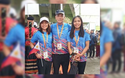 <p><strong>DOUBLE GOLD</strong>. The two winners of the 5,000-meter run in the 21st Asia Masters Athletics Championships in Kuching, Malaysia. Christabel Martes (right) and Nhea Ann Barcena after winning in their respective age brackets last Monday (Dec. 2). The two Filipina runners pose with Dennis Scott, a fellow participant to the master's event who was the 2019 gold medalist at 3000m, 1500m, 800m and 400m at the 9th Sabah Masters Athletics Open Championships 2019. <em>(Photo from the FB of Dennis Scott)</em></p>