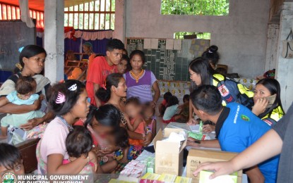 <p><strong>REBEL PLOY?</strong> Municipal health workers and police officers (left) of Kitaotao and Quezon towns in Bukidnon province help distribute medicines and provide medical and psychosocial services to the 25 Manobo families inside the compound of Iglesia Filipina Independiente on Monday (Dec. 2, 2019). The families fled their village in Quezon town following false reports that the military was going to bomb their village. <em>(Photo courtesy Quezon, Bukidnon LGU)</em></p>