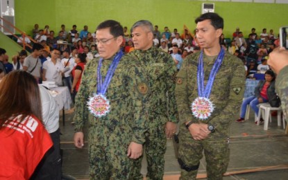 <p><strong>MEDICAL, DENTAL MISSION.</strong> Officials (from left) Brig. Gen. Rene Pamuspusan, director of Police Regional Office-6; Col. Romeo Baleros, director of Negros Occidental Police Provincial Office; and Brig. Gen. Benedict Arevalo, commander of the Philippine Army’s 303rd Infantry Brigade, join the medical and dental mission for former New People’s Army members in Escalante City, Negros Occidental on Nov. 30, 2019. Some 1,400 persons availed of various services during the activity. <em>(Photo courtesy of Negros Occidental Police Provincial Office)</em></p>