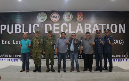 <p><strong>UNWELCOME.</strong> The City of Panabo in Davao del Norte officially declares the Communist Party of the Philippines-National Democratic Front-New People’s Army as persona non-grata on Monday (Dec. 2, 2019). Mayor Jose E. Relampagaos (4th from left) leads the declaration in accordance with President Rodrigo Duterte’s Executive Order 70. <em>(Photo courtesy of the City government of Panabo)</em></p>