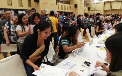 <p><strong>JOB HUNT.</strong> A job seeker hands her resume to a company representative during the December job expo of the Iloilo Public Employment Services Office (PESO) at Grand Xing Hotel in this city on Wednesday (Dec. 4, 2019). Francisco Heler, PESO-Iloilo chief, said 125 applicants secured jobs during the fair. <em>(PNA Photo by Gail Momblan)</em></p>