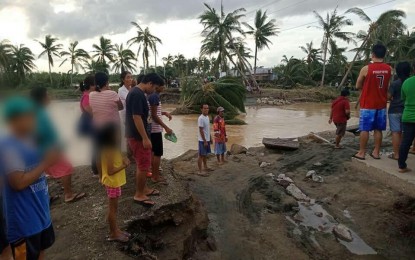 <p><strong>TYPHOON'S IMPACT.</strong> Residents check a damaged road linking San Roque and Catarman towns in Northern Samar after Typhoon Tisoy crossed the province this week. The towns of Catarman and Gamay in Northern Samar were placed under state of calamity on Wednesday (Dec. 4, 2019).  <em>(Photo courtesy of the Philippine Red Cross)</em></p>