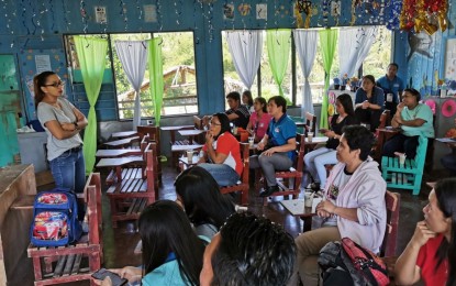 <p><strong>HELP FOR TRAUMA.</strong> Lawyer Elisa Lapiña (standing), municipal administrator of Sto. Tomas, Davao del Norte, leads psychosocial activities for parents, teachers and students of the Magwawa Integrated School in the town on Friday (Dec. 7, 2019). The interventions came after government troops figured in a firefight with the New People's Army a day earlier in nearby Barangay Colosas, Paquibato District in Davao City. <em>(Photo courtesy of Sto. Tomas MIO)</em></p>