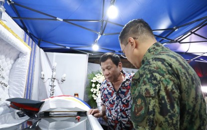 <p><strong>HERO COP.</strong> President Rodrigo Duterte pays his last respects to the late Police Senior Master Sergeant Jason Magno as he visits the wake in Initao, Misamis Oriental on Thursday (Dec. 5, 2019). Magno sacrificed his life to protect students from a grenade explosion inside a college campus in Initao. <em>(Presidential Photo)</em></p>