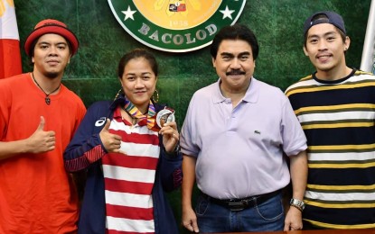 <p><strong>HOMEGROWN MEDALIST</strong>. Bacolod City Mayor Evelio Leonardia (2nd from right) poses with 30th Southeast Asian Games dancesport silver medalist Debbie Mahinay (2nd from left), and her trainers Jake Louwen Benamer and Brylle Sy, during the group’s courtesy call at the Bacolod Government Center on Friday (Dec. 6, 2019). Mahinay got a podium finish in the Breaking B-Girls category of the competition held at the Royce Hotel in Clark, Pampanga on Dec. 1, 2019. <em>(Photo courtesy of Bacolod City PIO)</em></p>