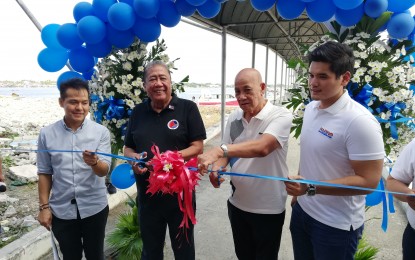<p><strong>FREE FERRY RIDES. </strong>Department of Transportation (DOTr) Secretary Arthur Tugade (2nd from left) and other officials cut the ceremonial ribbon during the launch of the Cavite - Manila Ferry Service at the Cavite City Port Ferry Terminal (CCPT) on Sunday (Dec. 8). During the launch, both operators of the ferry service agreed to a one-month long free period after a request from Tugade. <em>(Photo by Raymond Carl Dela Cruz)</em></p>