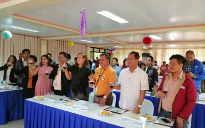 <p><strong>TRANSNATIONAL EDUCATION.</strong> Dr. Rhodora S. Crizaldo (1st row, 4th from left), program manager of the Higher Education Cooperation Towards Transnational Education Open Resource (HECTOR) project, leads the ceremonial toast during the Grand Inception Meeting to promote awareness on the project and encourage more Higher Education Institutions (HEIs) in the Philippines to promote transnational education, held at the Cavite State University (CvSU) in Indang, Cavite on Monday (Dec. 9, 2019). The two-year HECTOR research project, initiated by CvSU in collaboration with the Technological University of the Philippines (TUP) is funded by the Commission on Higher Education (CHED). <em>(PNA photo by Gladys S. Pino)</em></p>