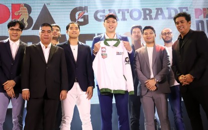 <p><strong>TOP PBA DRAFT PICK</strong>. Isaac Go receives a Columbian Dyip jacket after he was selected as the first pick of the 2019 PBA Draft at the Robinsons Place Manila Atrium on Sunday night (Dec. 8, 2019). Go said to be the first overall draft pick is "challenging". <em>(Photo courtesy of PBA Media Group)</em></p>
<p> </p>