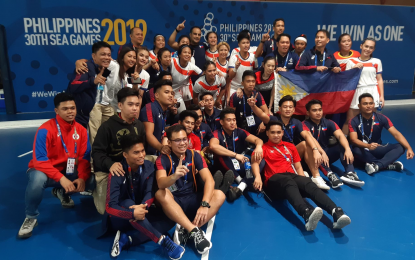 <p><strong>ACHIEVER</strong>. Both the Philippine men's and women's indoor hockey teams take a picture together after the female side won over Cambodia, 4-3, in their SEA Games match at the Centtro Convention Center in Los Baños on Saturday night (Dec. 7, 2019). The win eventually put the team in the semifinals. <em><strong>(PNA photo by Ivan Saldajeno)</strong></em></p>