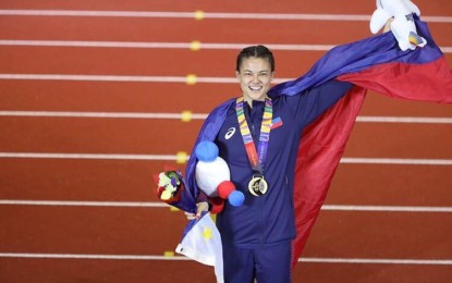 <p><strong>GOLDEN DEBUT</strong>. Pole vaulter Natalie Rose Uy waves to the crowd after receiving her gold medal for winning the women’s pole vault in athletics competitions of the 30th Southeast Asian Games at the New Clark City Athletics Stadium in Capas, Tarlac on Sunday night (Dec. 8, 2019). After her golden debut in the biennial meet, Uy is hoping to take a crack at qualifying for 2020 Tokyo Olympics. <em>(Photo courtesy of Natali Uy’s Facebook account)</em></p>