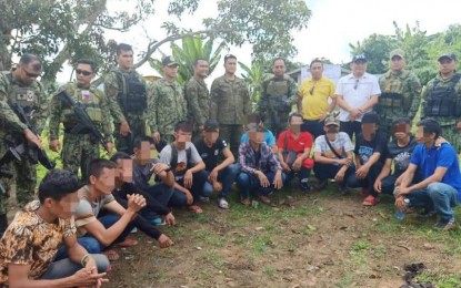 <p><span lang="EN-US"><strong>SURRENDERERS.</strong> Police and Army officials in Sarangani province pose with 13 former members of the New People's Army who surrendered on Monday (Dec. 9, 2019) in the upland barangay of Sapu Masla, Malapatan town. The rebels were reportedly convinced to surrender during simultaneous internal security operations in the area. <em>(Photo courtesy of the PRO-12)</em></span></p>
