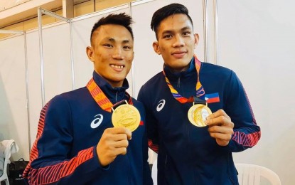 <p><strong>NEGRENSE PRIDE</strong>.  Rogen Ladon (left), and James Palicte of Bago City, Negros Occidental, won the gold medals in men’s boxing flyweight and welterweight divisions, respectively, during the 30th Southeast Asian (SEA) Games held at the PICC Forum on Monday (Dec. 9, 2019). Team Philippines ruled boxing with a haul of seven gold medals, three silvers and two bronze medals. (<em>Photo courtesy of The Citybridge Bago City Newsletter</em>) </p>
<p> </p>