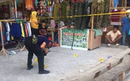 <p><strong>INVESTIGATION.</strong> A police crime scene investigator gathers pieces of evidence in the killing of Basit Macmod Taguigaya, a former village chair of Barangay Poblacion, Shariff Saydona Mustapha, Maguindanao. Taguigaya was shot at a second-hand clothing store in Barangay Rosary Heights 10, Cotabato City on Wednesday (Dec. 11, 2019). <em>(Photo courtesy of CCPO)</em></p>