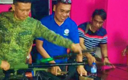 <p><strong>FIREARMS TURNOVER.</strong> Military and local officials in Datu Saudi Ampatuan, Maguindanao inspect the firearms to be turned over to government forces during the town's peace and order council meeting on Wednesday (Dec. 11, 2019). The town officials, led by Mayor Edris Sindatok, committed to support the government’s disarmament campaign even after the reported lifting of martial law in Mindanao by yearend. <em>(Photo courtesy of 6ID)</em></p>