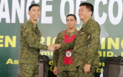 <p><strong>CHANGING OF THE GUARD.</strong> Army Brig. Gen. Eric Vinoya (center), commander of the 3rd Infantry Division, presides over the change of command of the 303rd Infantry Brigade at Camp Maj. Nelson Gerona in Murcia, Negros Occidental on Thursday (Dec. 12, 2019). Vinoya ordered Col. Inocencio Pasaporte (right), who succeeded Brig. Gen. Benedict Arevalo (left), to continue the fight against communist insurgency in Negros Island. <em>(PNA photo by Nanette L. Guadalquiver)</em></p>