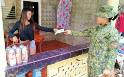 <p><strong>COMMUNITY INVOLVEMENT.</strong> A female police officer hands over a leaflet to a young woman that contained information on how to help prevent violence and terrorism in North Cotabato. The provincial police office has raised its alert status for the Christmas season as a precautionary measure against threats to peace and security. <em>(Photo courtesy of North Cotabato PPO)</em></p>
