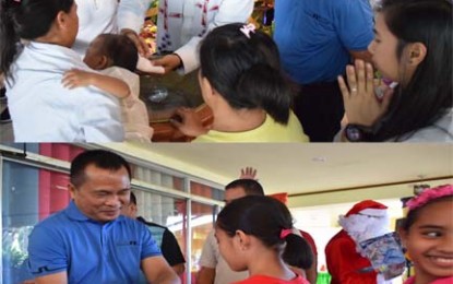 <p><strong>SANTA CLAUS, GODFATHER.</strong> Lt. Gen. Cirilito Sobejana, Western Mindanao Command (Westmincom) chief, on Thursday (Dec. 12) stands as godfather in a mass baptism (upper photo) at the Westmincom Chapel. He also distributes Christmas gifts (lower photo) to children who are dependents of soldiers as the Westmincom celebrates the Yuletide Season. <em>(Photo courtesy of Westmincom Public Information Office)</em></p>
