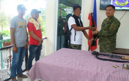 <p><strong>SURRENDER.</strong> Lt. Col. Rogelio S. Gabi, the Army’s 40th Infantry Battalion commander, receives a rifle from one of the three Bangsamoro Islamic Freedom Fighters who surrendered to the military in Gen. SK Pendatun, Maguindanao on Sunday (Dec. 15, 2019). The surrenderers claimed they have been duped by their former BIFF leaders into fighting a futile cause. <em>(Photo courtesy of 40IB)</em></p>