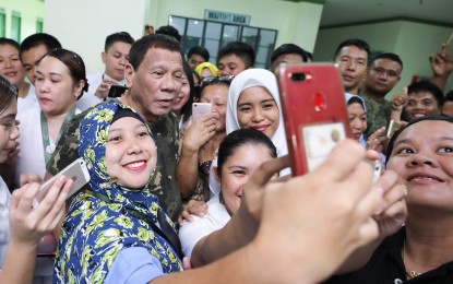 <p>President Rodrigo Duterte poses for a group picture in this undated photo <em>(Presidential Photo)</em></p>
