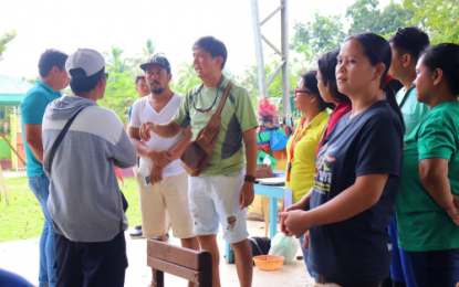 <p><strong>PRECAUTIONARY MEASURE.</strong> Kidapawan City Mayor Joseph Evangelista (green shirt) speaks to the residents of high-risk upland villages, explaining why they must move back to evacuation camps following Sunday’s (Dec. 15, 2019) earthquake. About 30 families were told to leave the city’s Barangay Umpan and Sitio Mawig of Barangay Balabag shortly after the 2 p.m. tremor that hit parts of North Cotabato and Davao del Sur provinces. <em>(Photo courtesy of Kidapawan CIO)</em></p>