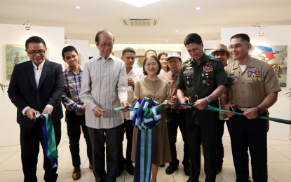 <p><strong>BRAVE ART.</strong> Armed Forces of the Philippines (AFP) Chief-of-Staff, Gen. Noel Clement (2nd from right), AFP spokesperson, Marine Brig. Gen. Edgard Arevalo (right) and Esther Garcia of Dynamic Art Group (middle) lead the ceremonial ribbon cutting of the Art Exhibit dubbed as "Sining at Kagitingan: Isang Pagpupugay sa ika-84 na Anibersaryo ng Sandatahang Lakas ng Pilipinas," at the Dimalupig Hall in Camp Aguinaldo, Quezon City on Tuesday (Dec. 17, 2019). The four-day painting exhibit is in line with the AFP's 84th anniversary which showcases paintings depicting the different aspects of a soldier's life. <em>(PNA photo by Joey O. Razon)</em></p>