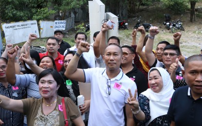 <p><strong>JUSTICE SERVED.</strong> Maguindanao 2nd Dist. Rep. Esmael “Toto” Mangudadatu (in white polo shirt) and relatives of the victims of the Maguindanao massacre raise their fists as some of the principal accused were found guilty of the crime, during the promulgation of the case at Camp Bagong Diwa in Taguig City on Thursday (Dec. 19, 2019). Mangudadatu's wife was among those killed in the massacre on Nov. 23, 2009. <em>(PNA photo by Joey O. Razon) </em></p>