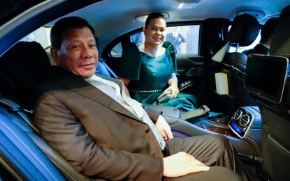 <p><strong>DUTERTE-DUTERTE 2022.</strong> President Rodrigo Duterte poses with his daughter, Davao City Mayor Sara Duterte, as they prepare to head for the Imperial Palace in Tokyo, Japan for the ceremony for the Accession to the Throne of Emperor Naruhito on October 22, 2019. A recent survey released by political consultancy firm PUBLiCUS Asia, Inc. showed that the daughter-father tandem emerged as the top candidates for the two highest positions in government in 2022. <em>(File presidential photo)</em></p>