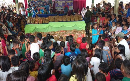 <p><strong>SPIRIT OF CHRISTMAS.</strong> More than a thousand residents from tribal communities in the towns of Lianga and Tago in Surigao del Sur receive gifts from the Army's 3rd Special Forces Battalion and support groups during the three-day Christmas activity conducted from December 14 to 17 this year. The Army unit says the recipients live in areas affected by armed conflicts brought by the presence of communist rebels. <em>(Photo courtesy of 3SFBn Civil-Military Operations Office)</em></p>