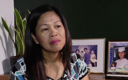 <p><strong>SKIPPING CHRISTMAS.</strong> Luisa Espina reminisces her time with daughter Louvaine Erika, whom she says has become a full-time activist under progressive youth group Anakbayan. She said they are not excited to celebrate Christmas this year because Louvaine has not yet come home.<em> (PNA photo)</em></p>