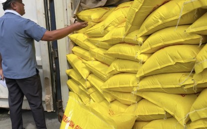 <p><strong>MISDECLARED</strong>. A personnel from the Bureau of Customs-Port of Cebu inspects the glutinous rice shipment from Vietnam misdeclared as "white rice" at the Cebu International Port (CIP) yard on Friday (Dec. 20, 2019). BOC-Cebu acting district collector Lawyer Charlito Martin Mendoza issued a warrant of seizure and detention (WSD) against the "entire shipment" of 10 container vans after the customs examiner found that five containers declared as white rice actually contained glutinous rice (super malagkit), which is a violation of the Customs Modernization and Tariff Act of 2016. <em>(Photo courtesy of BOC-Cebu)</em></p>