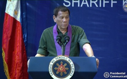 <p><strong>CLOA DISTRIBUTION.</strong> President Rodrigo Duterte delivers his speech during the distribution of Certificates of Land Ownership Award (CLOA) to agrarian reform beneficiaries in Cotabato City on Monday (Dec. 23, 2019). In his speech, the President said over-speeding, particularly of trucks, must be regulated, lamenting that it has been one of the country’s leading causes of deaths in road accidents. <em>(Screenshot from RTVM)</em></p>