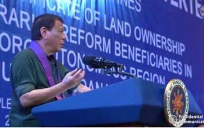 <p><strong>LOVE FOR THE BANGSAMORO.</strong> President Rodrigo Duterte speaks during his Dec. 23, 2019 visit to the compound of the Bangsamoro Autonomous Region in Muslim Mindanao in Cotabato City. Duterte led the distribution of 815 certificates of land ownership to 912 agrarian reform beneficiaries coming from the provinces of Maguindanao, Sulu, Tawi-Tawi, Lanao del Sur, and Basilan. <em>(Screengrab from PCOO television coverage)</em></p>
