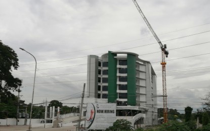<p><strong>PROPERTY BOOM.</strong> The real estate and commercial property developments that marked General Santos City’s growth these past years have continued, boosting the city’s standing as an emerging metropolis. Photo shows the eight-story Sarangani Bay Specialist Medical Center, the first high-rise project approved by the city government, now almost complete and is expected to finally open early next year. <em>(PNA photo by Allen V. Estabillo)</em></p>