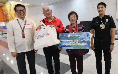 <p><strong>8-MILLIONTH VISITOR.</strong> Japanese couple Yachiyo (left) and Tamio Imamoto arrive at the Ninoy Aquino International Airport in Manila on Friday (Dec. 27, 2019). The Imamotos will receive a round-trip ticket from Japan to Manila and a tour to Siargao in 2020 as their visit marks the country's highest foreign arrival to date at eight million. <em>(Photo by Avito Dalan)</em></p>