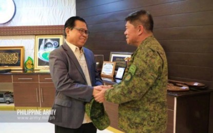<p><strong>CLOSE COORDINATION</strong>. Bangsamoro Autonomous Region in Muslim Mindanao Chief Minister Murad Ebrahim (left) and Philippine Army commander Lt. Gen. Gilbert Gapay shake hands during a meeting in Cotabato City on Friday (Dec. 27. 2019). Gapay has expressed his full support to BARMM’s Joint Peace and Security Team -- composed of soldiers, police and former Moro rebels -- tasked to protect the civilian communities during its transition to a fully established regional government by 2022. <em>(Photo courtesy of 6ID)</em></p>