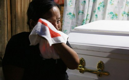 <p><strong>GRIEVING MOTHER.</strong> Erlinda Cabatchete grieves over the death of his son, Bertoldo, Jr. who died in Luzon of pneumonia last year while fighting for the New People's Army. Erlinda blamed the communist group for destroying his son's future.<em> (PNA photo by Alexander Lopez)</em></p>